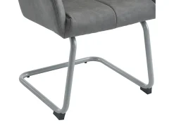 Conjunto de 2 sillas cantilever con reposabrazos, tapizado en símil piel gris, patas de metal color plata.