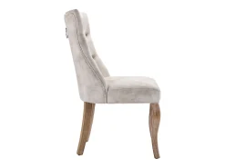 Conjunto de 4 sillas de terciopelo beige claro con patas de madera curvadas y botones decorativos.