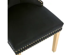 Juego de 2 sillas de cocina de terciopelo negro con estructura de metal dorado.