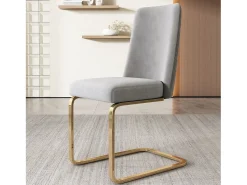 Juego de 4 sillas de comedor en terciopelo gris con respaldo tapizado y patas doradas.